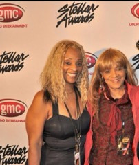 Two smiling women together in front of a Stellar Awards and gmc backdrop